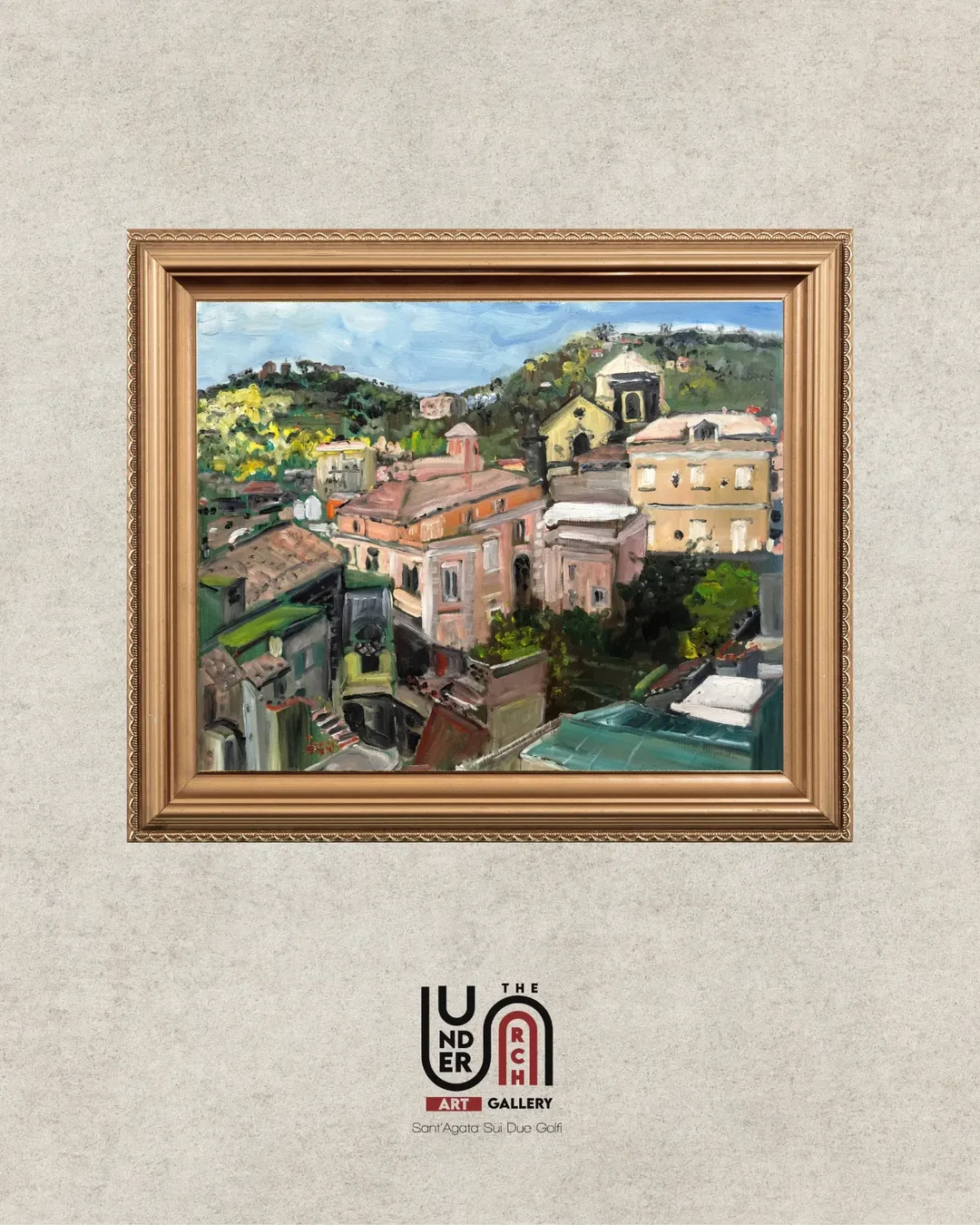A professional framed oil painting of a traditional Italian hillside village with yellow and peach buildings, set in a golden ornate frame.
